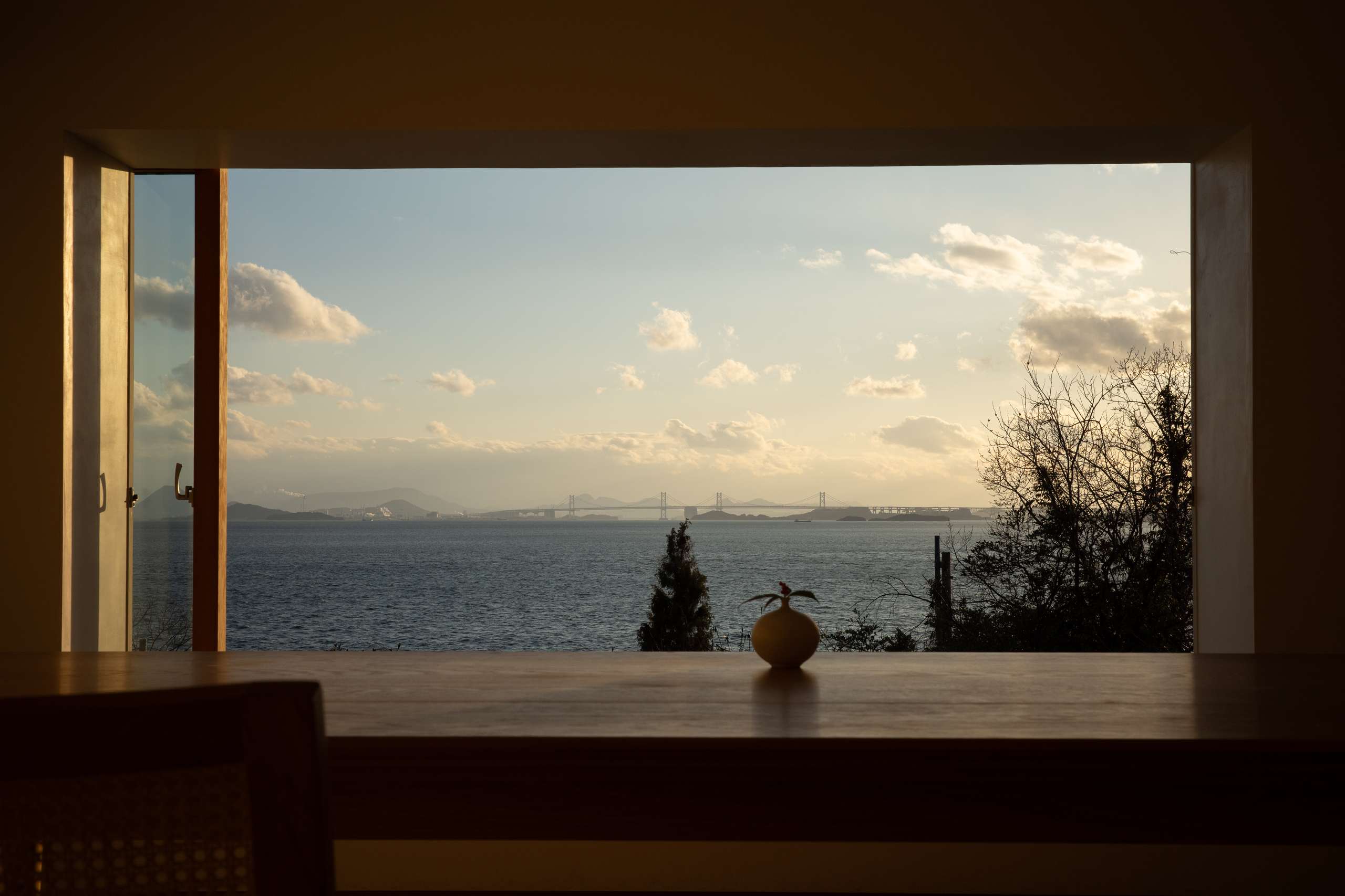 Muted red hallway with deep, directional shadow.