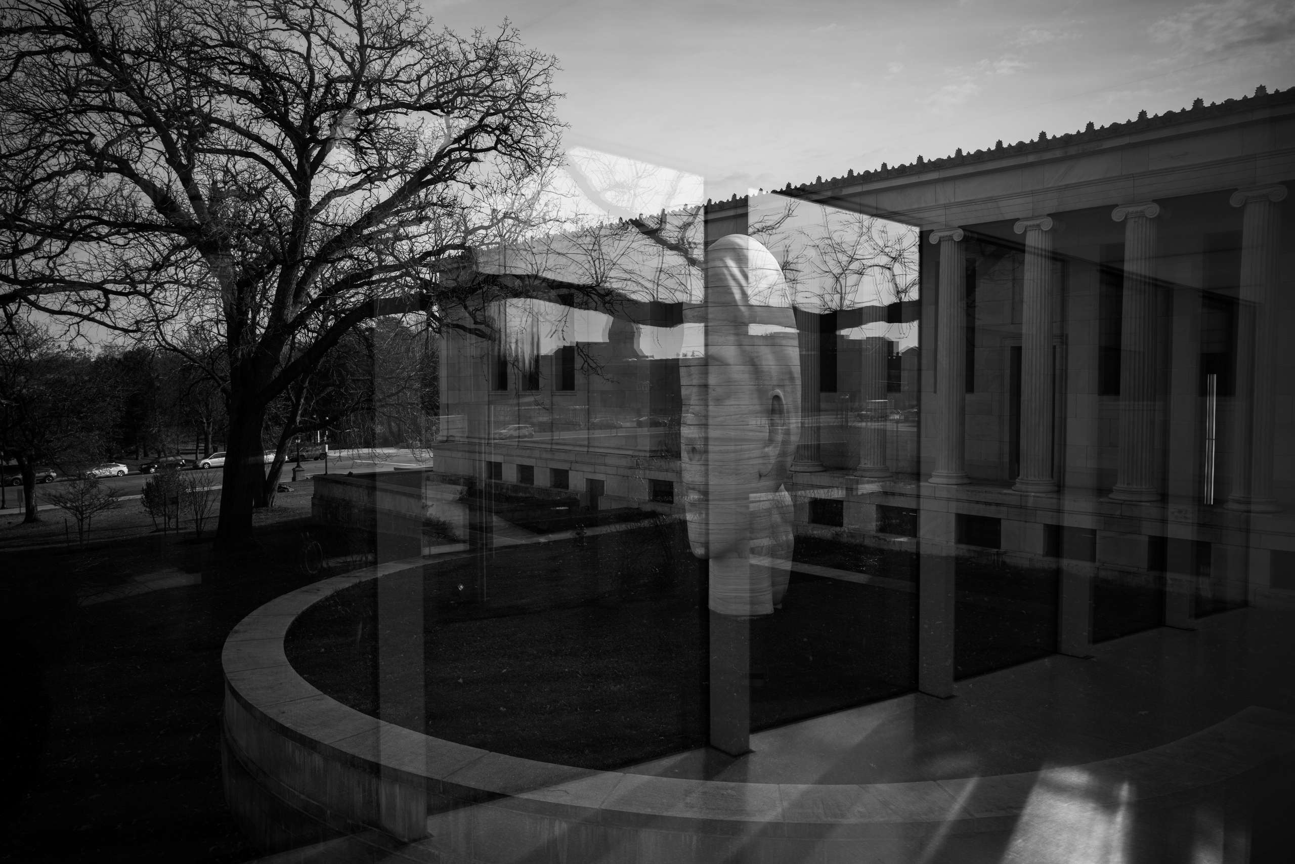 Rain-soaked intersection at night with reflected signage.
