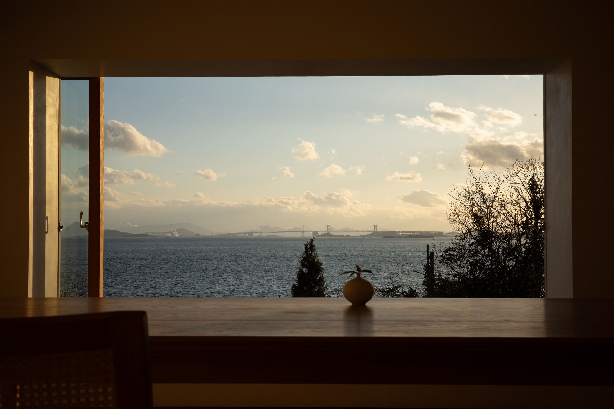 Muted red hallway with deep, directional shadow.
